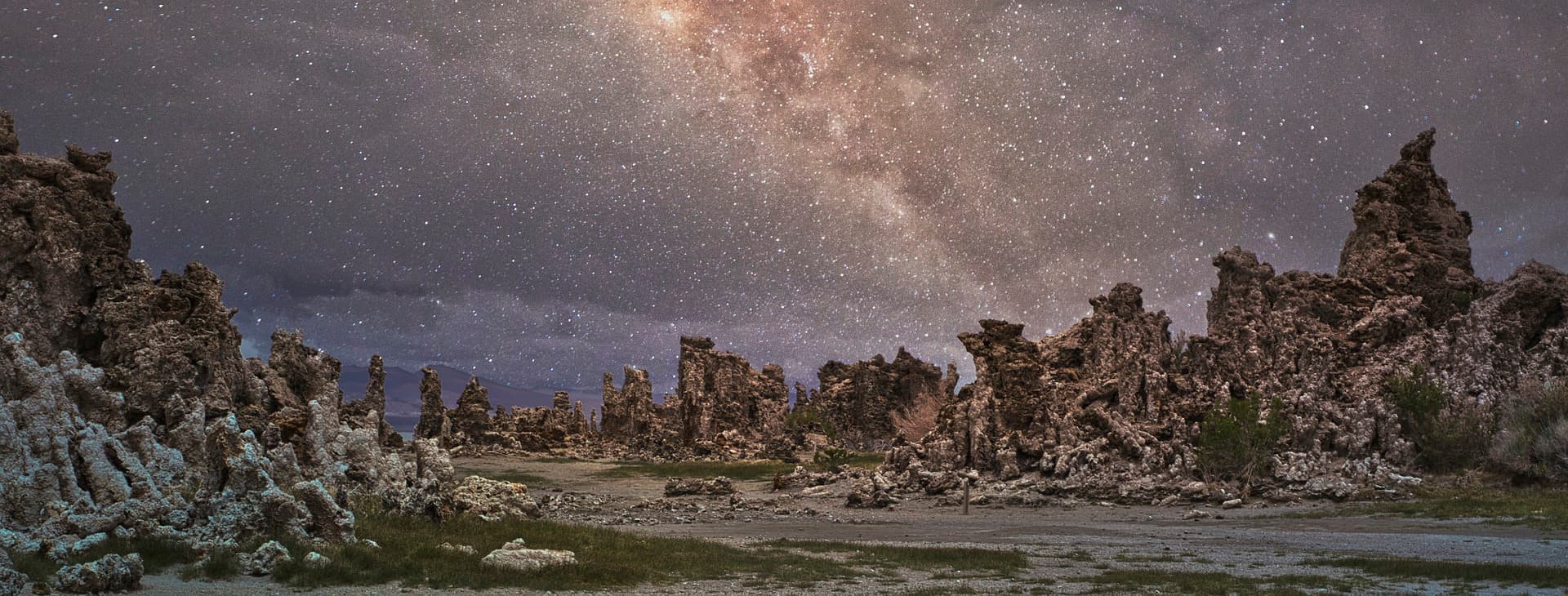 Desert rock spires beneath a dense field of stars